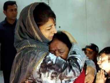 Jammu and Kashmir chief minister Mehbooba Mufti consoles an injured Amarnath pilgrim who survived the Anantnag militant attack, before she was airlifted to New Delhi at the airport in Srinagar on Tuesday. PTI