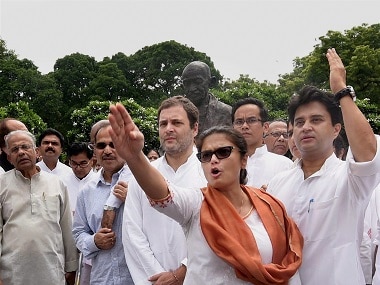 Opposition leaders protest in front of the Mahatma Gandhi statue. PTI