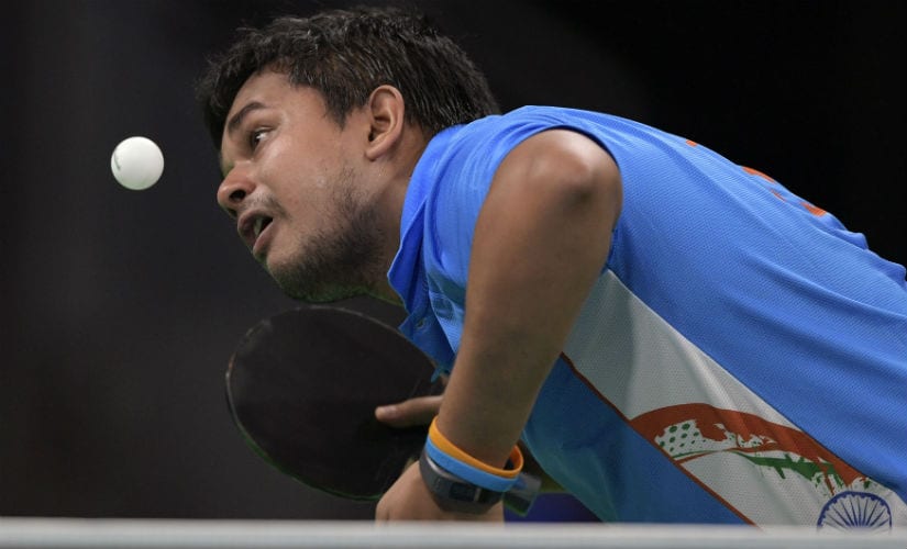 Soumyajit Ghosh eyes the ball in his men's singles qualification round table tennis match at the Riocentro venue during the Rio 2016 Olympics. AFP