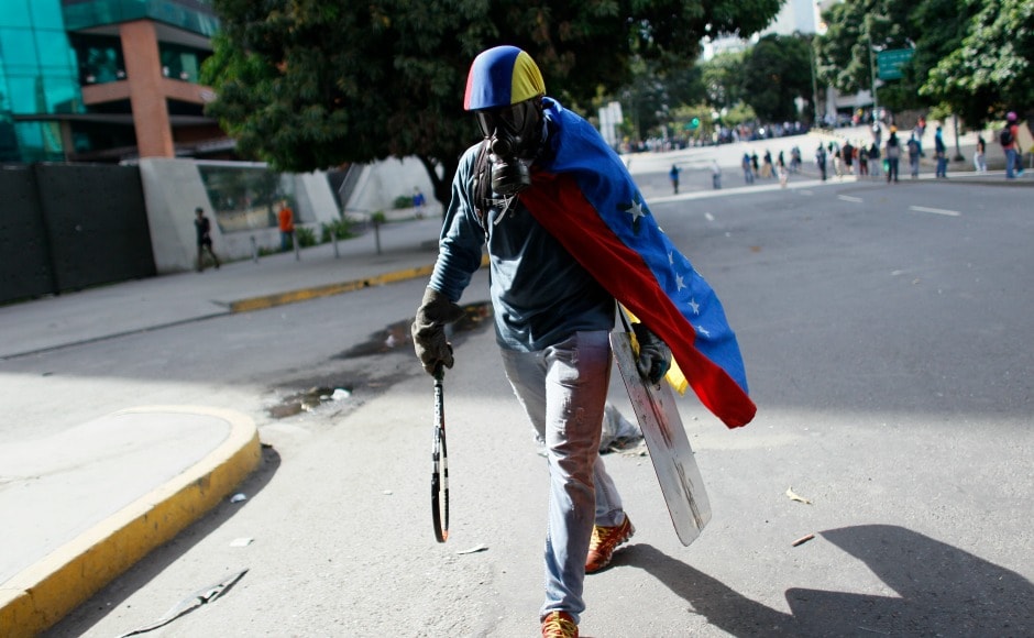 Protesters are often seen carrying make-shift weapons. The fear of a return to the pre-Chavez era is felt strongly by those who still support the government, many of whom live in the slums. AP Protesters are often seen carrying make-shift weapons. The fear of a return to the pre-Chavez era is felt strongly by those who still support the government, many of whom live in the slums. AP