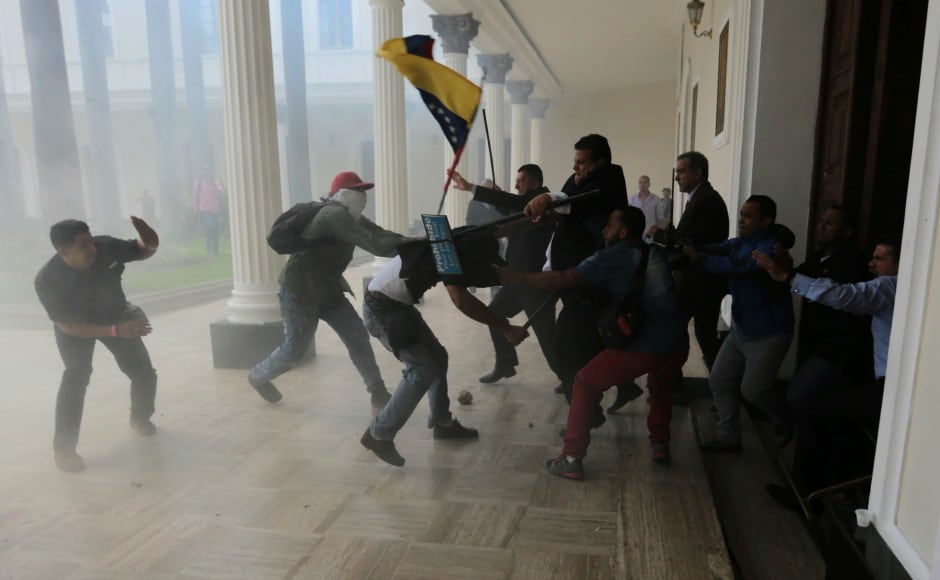 Opposition lawmakers brawled with pro-government militias who were trying to force their way into the National Assembly during a special session coinciding with Venezuela's independence day. AP Opposition lawmakers brawled with pro-government militias who were trying to force their way into the National Assembly during a special session coinciding with Venezuela's independence day. AP