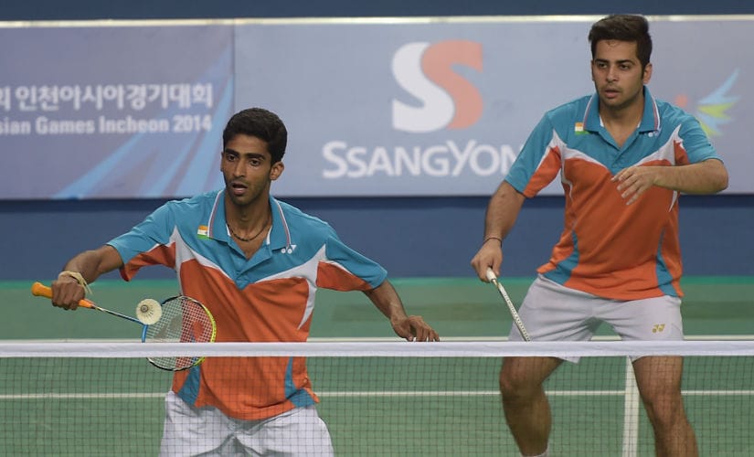 India's Buss Sumeeth Reddy (L) and Attri Manu (R) return a shot against Indonesia's Ahsan Mohammad and Setiawan Hendra during their badminton men's doubles quarter-final round match at the 2014 Asian Games in Incheon on September 26, 2014. AFP PHOTO / PORNCHAI KITTIWONGSAKUL / AFP PHOTO / PORNCHAI KITTIWONGSAKUL