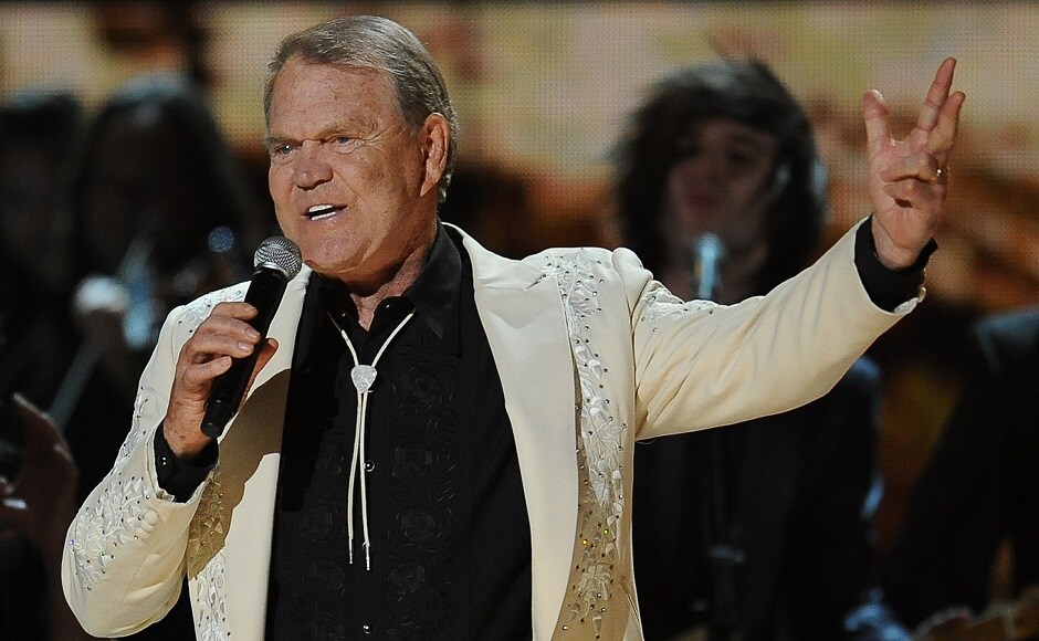 This photo taken on 12 February, 2012 shows Glen Campbell performing at the Staples Center during the 54th Grammy Awards in Los Angeles, California. Country music legend Glen Campbell, the 'Rhinestone Cowboy' who sold millions of albums over a career that spanned decades, has died at the age of 81 after a long battle with Alzheimer's disease, his family announced on 8 August , 2017. Image from AFP