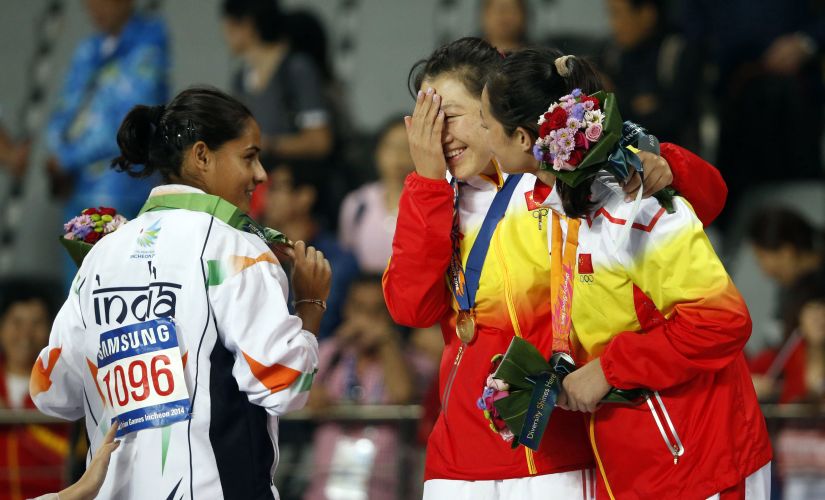 File photo of India's bronze medallist Rani Annu (L) posing with China's gold medallist Zhang Li (C) and silver medallist Li Lingwei during the medal ceremony for the women's javelin throw at the 17th Asian Games. Reuters