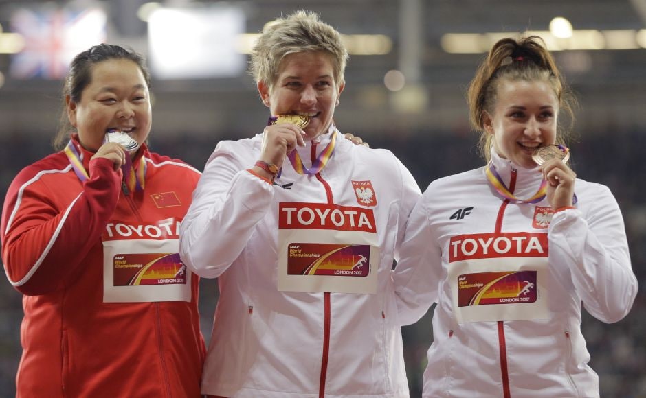Poland's Anita Wlodarczyk (cente) left it pretty late, but with one massive hammer throw she won her third world title. Early leader Wang Zheng of China (L) took silver with a throw of 75.98 meters and another Pole, Malwina Kopron (R), won bronze with a toss of 74.76. AP Poland's Anita Wlodarczyk (cente) left it pretty late, but with one massive hammer throw she won her third world title. Early leader Wang Zheng of China (L) took silver with a throw of 75.98 meters and another Pole, Malwina Kopron (R), won bronze with a toss of 74.76. AP