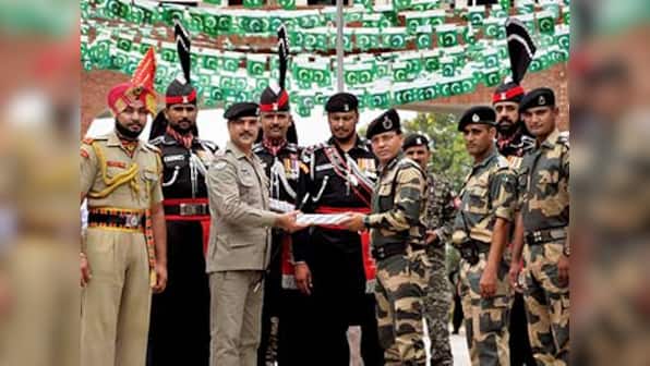 Pakistani Rangers offer sweets to Indian BSF personnel at Wagah border to celebrate independence day