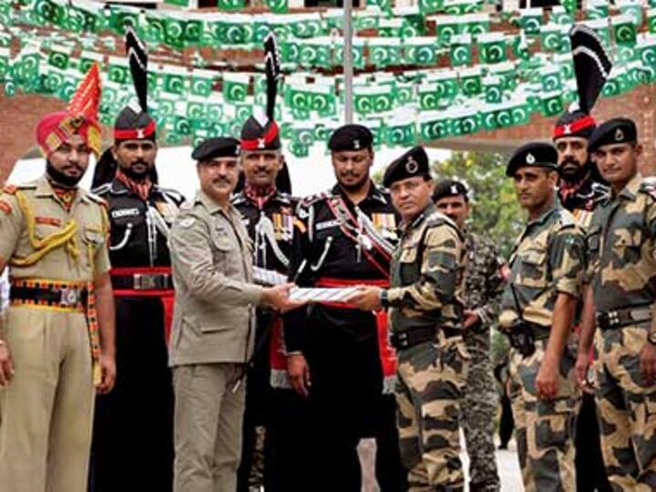 Pakistani Rangers offer sweets to Indian BSF personnel at Wagah border to celebrate independence day