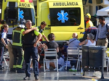 Injured people are treated in Barcelona, Spain, Thursday, Aug. 17, 2017 after a white van jumped the sidewalk in the historic Las Ramblas district, crashing into a summer crowd of residents and tourists and injuring several people, police said. (AP Photo/Oriol Duran)