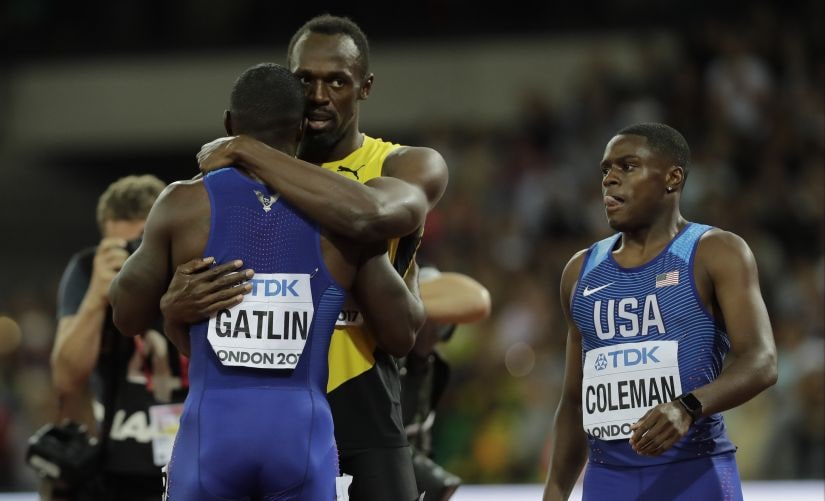 Usain Bolt, bronze, embraces gold medal winner Justin Gatlin as Christian Coleman who took the silver looks on after the men's 100m final during the World Athletics Championships. AP