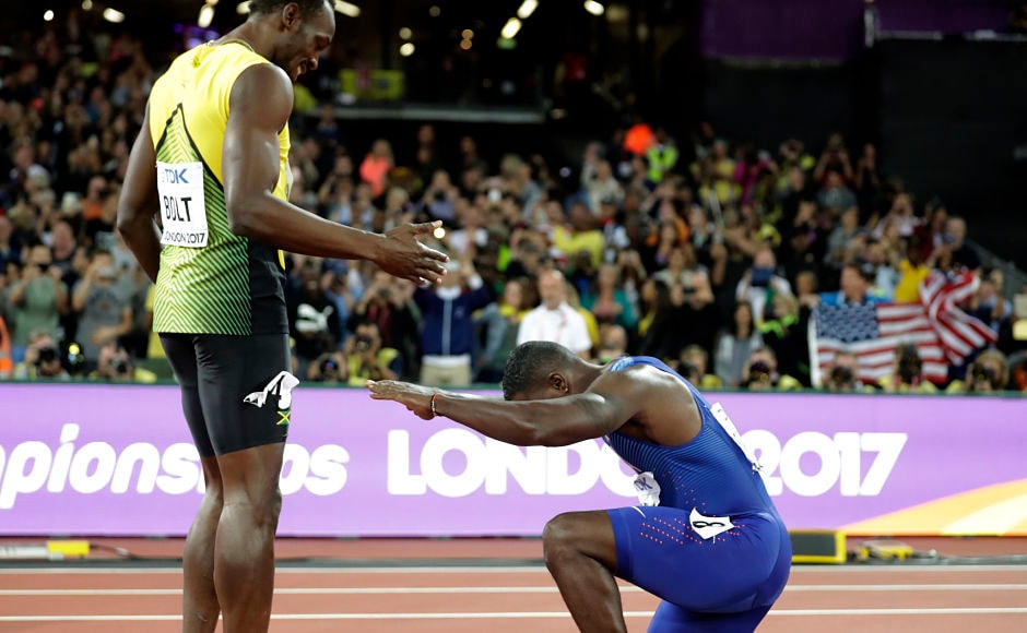Gold medal winner United States' Justin Gatlin knees in front of Jamaica's Usain Bolt, who won bronze, after the men's 100m final. AP