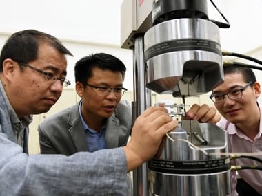 The research team uses a tensile machine to test the yield strength and elongation of steel. (From right): Dr He Binbin, Dr Huang Mingxin and Dr Luo Haiwen. The University of Hong Kong