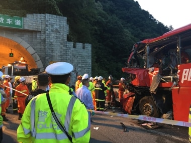 Police and firefighters work near the wreckage of the coach. Reuters