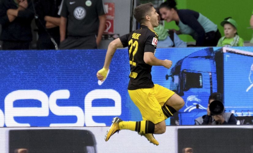 Dortmund's Christian Pulisic celebrates scoring the first goal of the game against Wolfsburg, during the German Bundesliga soccer match between VfL Wolfsburg and Borussia Dortmund in the Volkswagen Arena in Wolfsburg, Germany, Saturday Aug. 19, 2017. (Peter Steffen/dpa via AP)