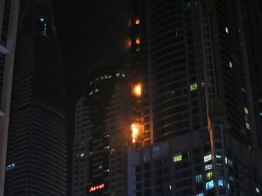 Smoke and fire rise from a high rise building at Marina district in Dubai, United Arab Emirates. AP