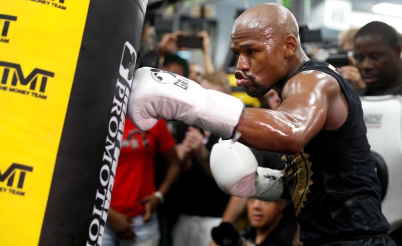 Floyd Mayweather hits a heavy bag during a workout at the Mayweather Boxing Club ahead of the super fight. Reuters