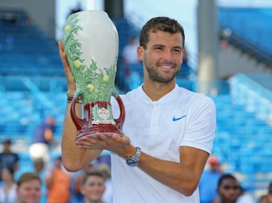 Grigor Dimitrov holds the Rookwood Cup after defeating Nick Kyrgios in the Cincinnati final. Reuters