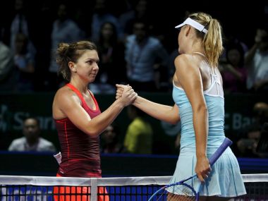 Simona Halep of Romania (L) congratulates Maria Sharapova of Russia after their women's singles tennis match of the WTA Finals at the Singapore Indoor Stadium October 27, 2015. REUTERS/Edgar Su - RTX1TGF5