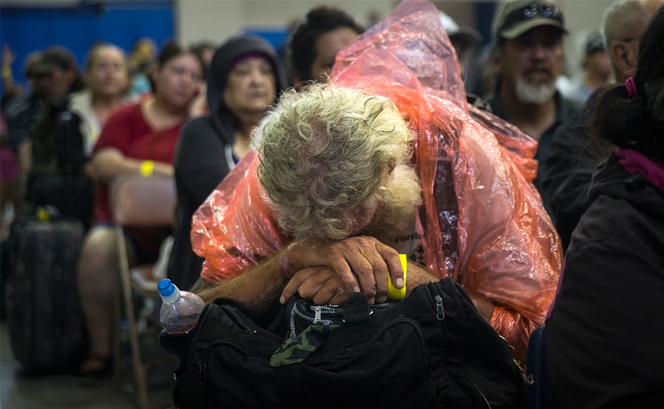 A man rests while waiting to board a bus headed for San Antonio at an evacuation center in Corpus Christi. Hundreds of the area's residents boarded buses on Friday to be transported to a shelter in San Antonio as Hurricane Harvey hit the Texas coast on Friday night. AP A man rests while waiting to board a bus headed for San Antonio at an evacuation center in Corpus Christi. Hundreds of the area's residents boarded buses on Friday to be transported to a shelter in San Antonio as Hurricane Harvey hit the Texas coast on Friday night. AP