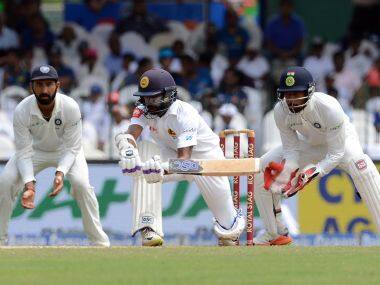 Sri Lanka’s Niroshan Dickwella (C) is watched by India’s wicketkeeper Wriddhiman Saha (R) as he plays a shot. AFP