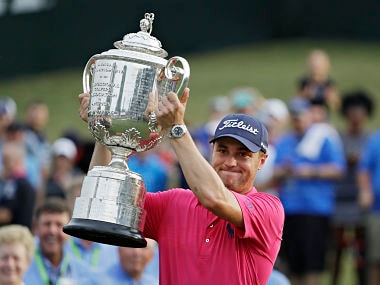 Justin Thomas poses with the Trophy after winning the PGA Championship. AP