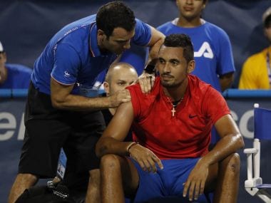 Aug 2, 2017; Washington, DC, USA; Nick Kyrgios of Australia receives treatment from an ATP trainer during an injury timeout against Tennys Sandgren of the United States (not pictured) on day three of the Citi Open at Fitzgerald Tennis Center. Sandgren won 6-3, 3-0 (Ret'd). Mandatory Credit: Geoff Burke-USA TODAY Sports - RTS1A6QH