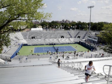 Children climb the bleachers at the temporary Louis Armstrong Stadium at US Open. AP