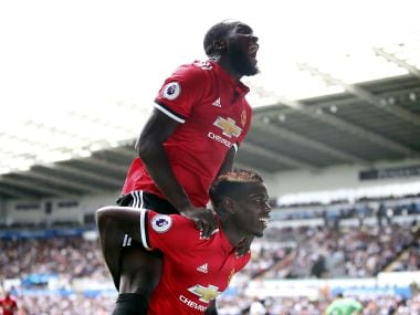 Manchester United's Paul Pogba on ground, celebrates scoring his side's third goal with team-mate Romelu Lukaku, during the English Premier League soccer match between Swansea and Manchester United, at the Liberty Stadium, in Swansea, Wales, Saturday Aug. 19, 2017. (Nick Potts/ PA via AP)