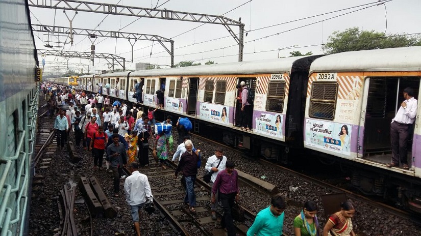 Mumbai rains: Crawling local trains, lack of buses make journey home difficult a day after heavy downpour Mumbai rains: Crawling local trains, lack of buses make journey home difficult a day after heavy downpour