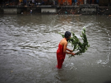 A Nepali woman lashes herself with the leaves of an Aghada herb as part of a ritual to wash away sins committed during menstruation period. AP