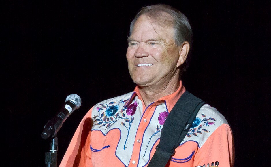 FILE - This 6 September, 2012 file photo shows singer Glen Campbell performing during his Goodbye Tour in Little Rock, Ark. Campbell, the grinning, high-pitched entertainer who had such hits as 'Rhinestone Cowboy' and spanned country, pop, television and movies, died Tuesday, 8 August, 2017. He was 81. Campbell announced in June 2011 that he had been diagnosed with Alzheimer's disease. (AP Photo/Danny Johnston, File)