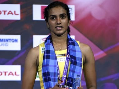 PV Sindhu poses with her silver medal on the podium after her defeat to Nozomi Okuhara. AFP