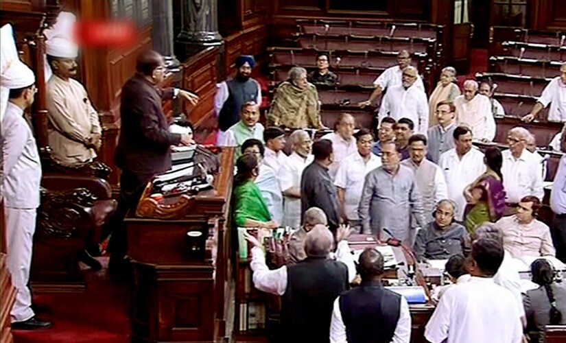 Congress MPs are seen in the Well of the Rajya Sabha during the ongoing monsoon session of Parliament, in New Delhi on Wednesday. PTI