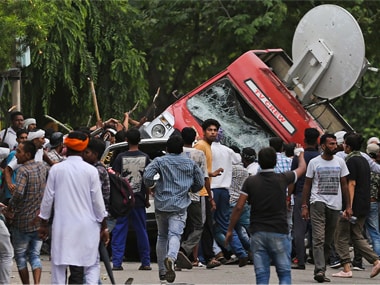 Dera supporters attack mediapersons on Friday after the verdict was announced. PTI