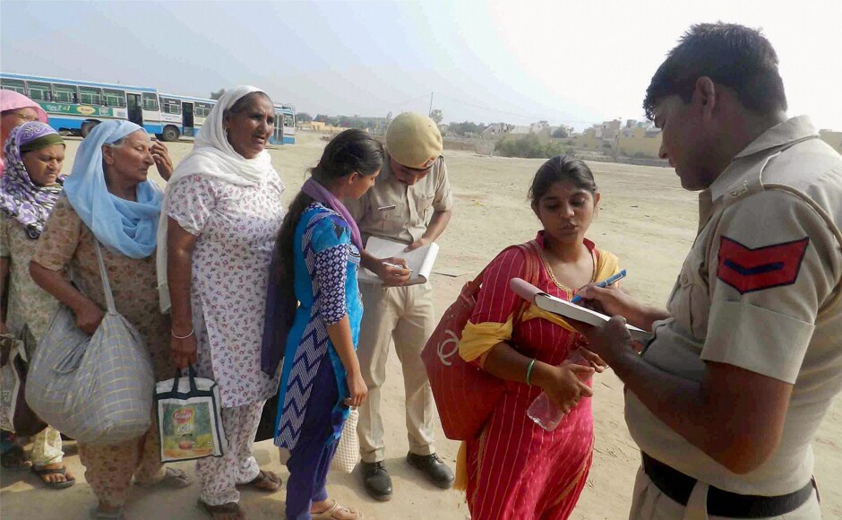 Dera Sacha Sauda followers queue up for police formalities before boarding the Haryana Roadways buses provided by the administration to return to their respective places, in Sirsa district on Monday. PTI Dera Sacha Sauda followers queue up for police formalities before boarding the Haryana Roadways buses provided by the administration to return to their respective places, in Sirsa district on Monday. PTI