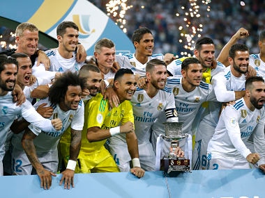 Real Madrid's players pose with the trophy after winning the Spanish Super Cup against Barcelona. AP