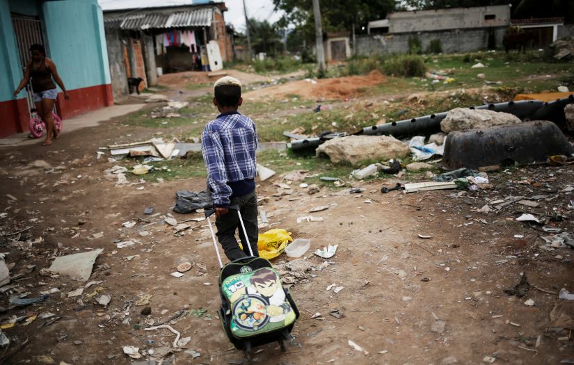 A boy pulls his school bag at a favela, or a slum, in Rio de Janeiro. Reuters