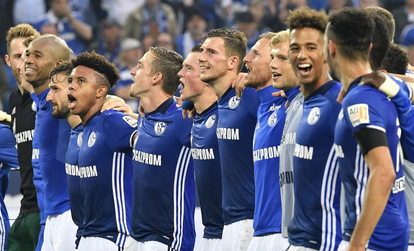 Schalke's team celebrates with supporters after the German Bundesliga soccer match between FC Schalke 04 and RB Leipzig at the Arena in Gelsenkirchen, Germany, Saturday Aug. 19, 2017. Schalke defeated Leipzig with 2-0. (AP Photo/Martin Meissner)