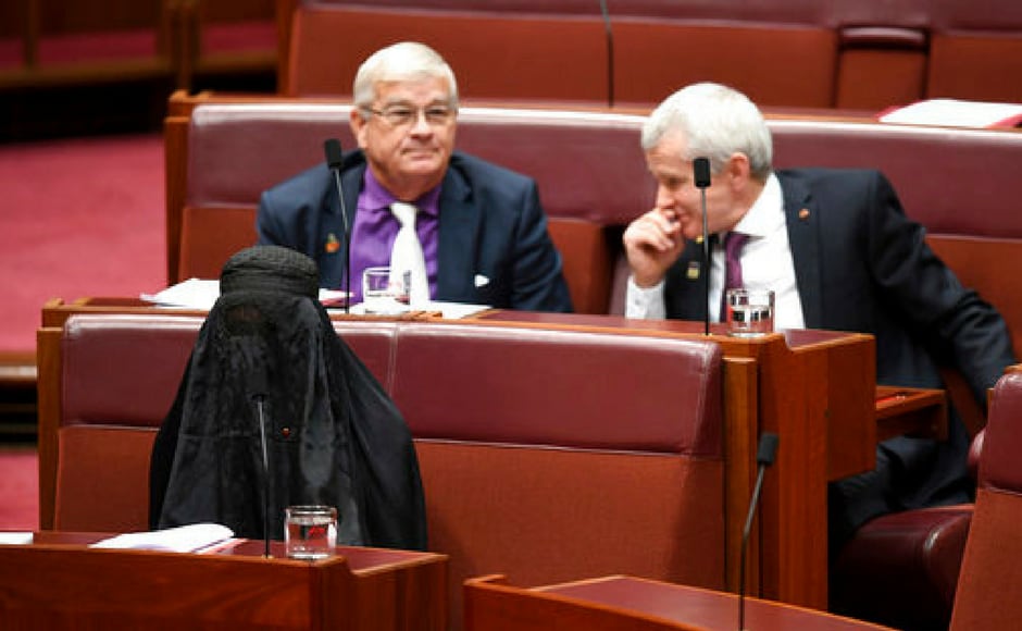 Senator Pauline Hanson, bottom left, wears a burqa during question time in the Senate chamber at Parliament House in Canberra, Australia on Thursday. Hanson, leader of the anti-Muslim, anti-immigration One Nation minor party, sat wearing the black head-to-ankle garment for more than 10 minutes before taking it off as she rose to explain that she wanted such outfits banned on national security grounds. AP Senator Pauline Hanson, bottom left, wears a burqa during question time in the Senate chamber at Parliament House in Canberra, Australia on Thursday. Hanson, leader of the anti-Muslim, anti-immigration One Nation minor party, sat wearing the black head-to-ankle garment for more than 10 minutes before taking it off as she rose to explain that she wanted such outfits banned on national security grounds. AP