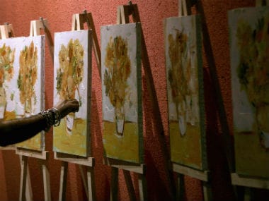 A painter draws imitation of van Gogh's 'Sunflower'. Reuters.