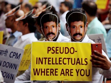 RSS workers display placards during the protest at Jantar Mantar in New Delhi on Wednesday. PTI