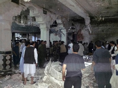Civilians and security forces inside the mosque after the suicide attack. AP