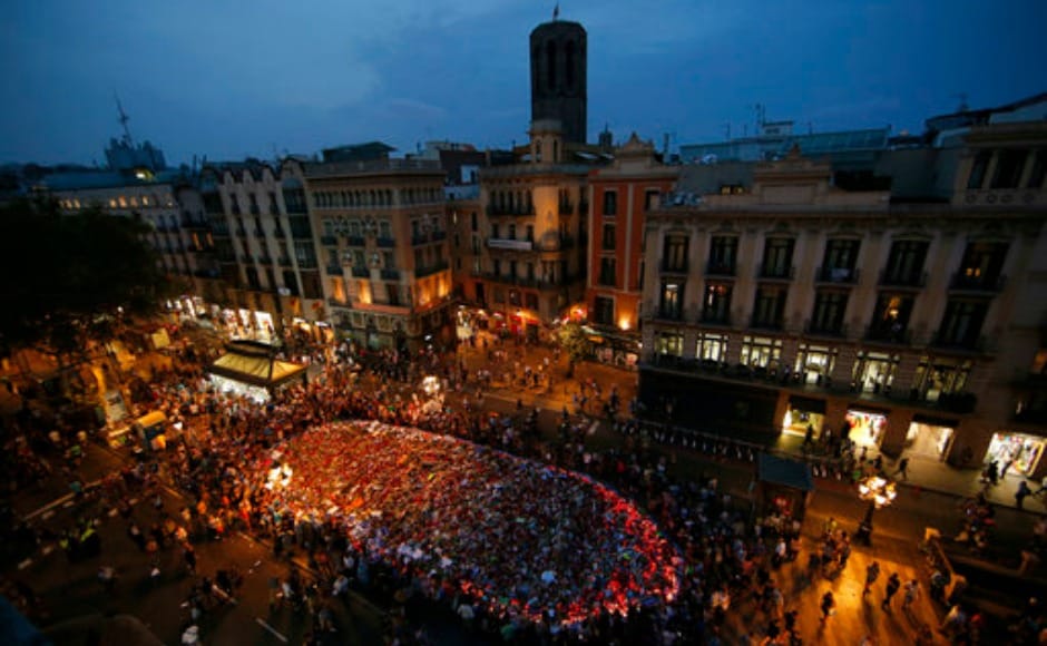 People stand around the memorial of flowers, messages and candles after the demonstration ended. The march concluded at Plaza de Catalunya near Las Ramblas. AP People stand around the memorial of flowers, messages and candles after the demonstration ended. The march concluded at Plaza de Catalunya near Las Ramblas. AP