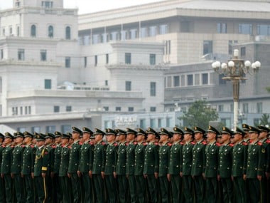 Chinese paramilitary policemen stand in formation on Tiananmen Square after attending the ceremony on Tuesday. AP