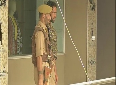 Police outside Alkhudam tours and travels in Srinagar. Twitter @ANI