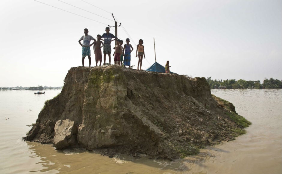 Around 1.38 crore people are still battling the deluge in 18 districts of the state. With water receding in some places, many people have returned home. AP Around 1.38 crore people are still battling the deluge in 18 districts of the state. With water receding in some places, many people have returned home. AP