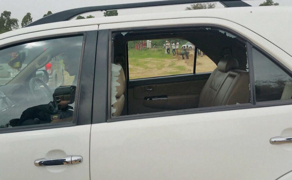 Gandhi's car was also pelted with stones breaking its rear glass but he espaced unhurt. Gandhi also alleged that several cars in his convoy was damaged, their window panes smashed and an SPG man suffered minor injury. PTI Gandhi's car was also pelted with stones breaking its rear glass but he espaced unhurt. Gandhi also alleged that several cars in his convoy was damaged, their window panes smashed and an SPG man suffered minor injury. PTI