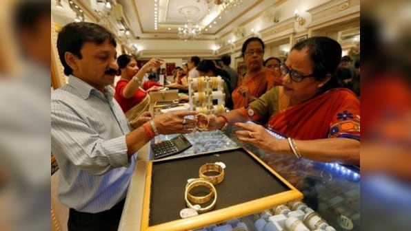 Gold prices rally Rs 455 to Rs 41,610 per 10 gram on rupee depreciation, global cues; silver declines by Rs 1,283