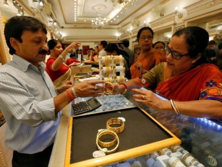 Gold prices rally Rs 455 to Rs 41,610 per 10 gram on rupee depreciation, global cues; silver declines by Rs 1,283
