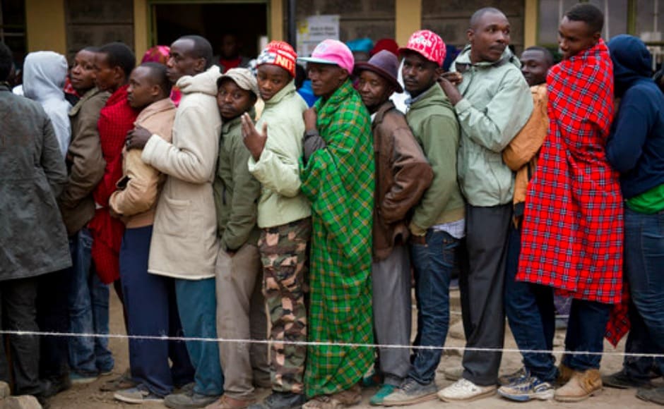 Kenyans line up to vote in Bissil , 120 km south of Nairobi, Kenya,Tuesday, Aug. 8, 2017. Kenyans are going to the polls to vote in a general election after a tightly-fought presidential race between incumbent President Uhuru Kenyatta and main opposition leader Raila Odinga. (AP Photo/Jerome Delay)