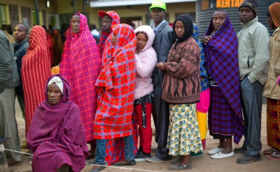 Kenyans line up to vote in Bissil , 120 km south of Nairobi, Kenya,Tuesday, Aug. 8, 2017. Kenyans are going to the polls to vote in a general election after a tightly-fought presidential race between incumbent President Uhuru Kenyatta and main opposition leader Raila Odinga. (AP Photo/Jerome Delay)